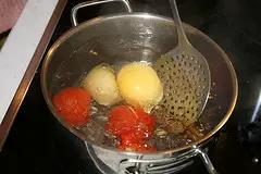 Die Tomaten in kochendes Wasser geben